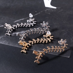 Leaf-shaped alloy ear clips with gold and silver plating and clear crystal accents