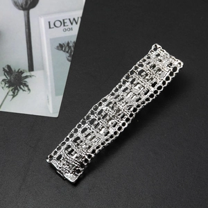 Silver rectangular metal hair clip featuring intricate hollow mesh texture on leather