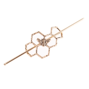 Detailed view of an antique gold honeycomb hair stick featuring a delicate bee motif