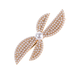 Elegant gold metal hair clip with cross leaf design and micro-pave white pearls