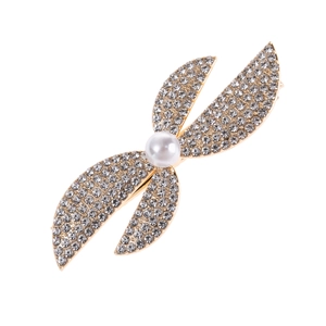 Detail of elegant gold hairpin with sparkling rhinestones and a white pearl accent