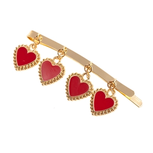 Detail of a gold alloy hairpin with four red heart pendants and small golden beads