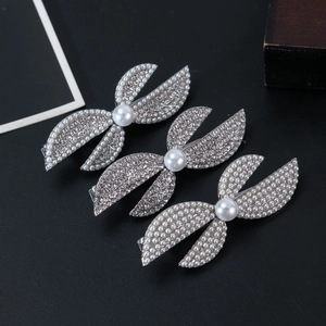 Detail shot of 3-piece silver hair clip set with sparkling rhinestones and white pearls