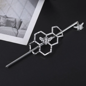 Detail view of retro silver hair stick with honeycomb cells and 3D bee pendant