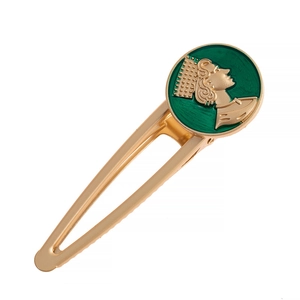 Detail view of a vintage alloy hair clip with a green enamel queen portrait relief charm