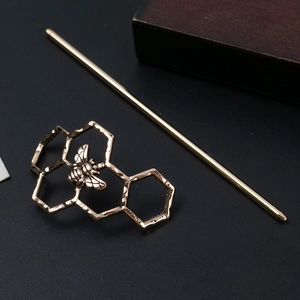 Vintage golden hair stick featuring honeycomb base and a detailed bee charm design