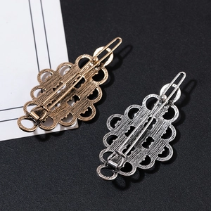 Vintage hollow metal hair clips in bronze and silver set with retro floral pattern