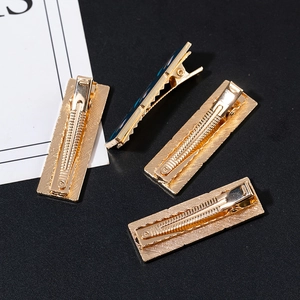 Set of four gold-plated metal hair clips with blue enamel for summer vintage hair styles