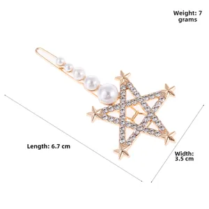 Detail view of gold star hair clip with crystals and five graduated white pearls