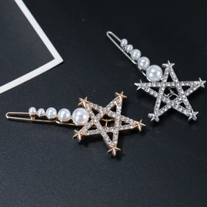 Detailed view of hollow star hairpins with sparkling rhinestones and gradient pearls