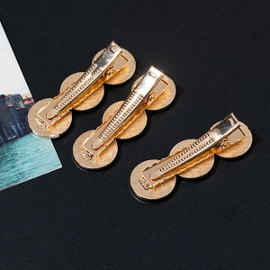 Three-piece set of French vintage gold metal rose pattern hair clips on black background