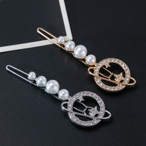 Detail of elegant planet hair clips with white pearls and sparkling rhinestone rings