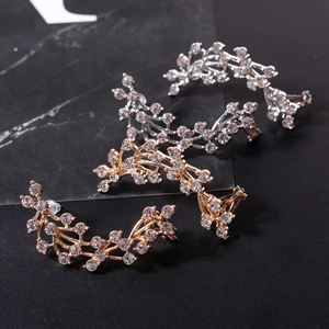 Detailed view of silver and gold grape cluster earrings with sparkling rhinestones