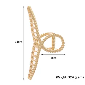 Macro detail of large matte gold twist hair claw clip with dimensions 11cm and 4cm
