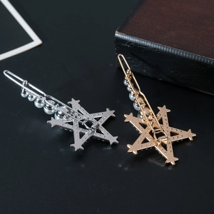 Elegant silver and gold hollow star hairpins with pearls on a dark background