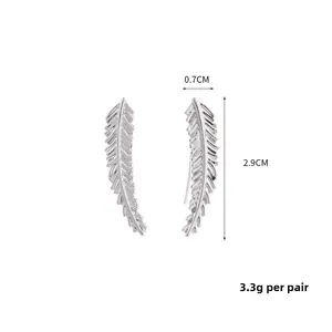 Detailed view of silver feather earrings showing dimensions 2.9cm by 0.7cm and texture