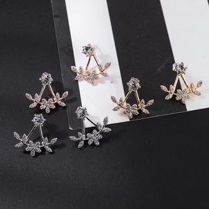 Detailed set of three floral jacket earrings in gold, silver, and rose gold finishes