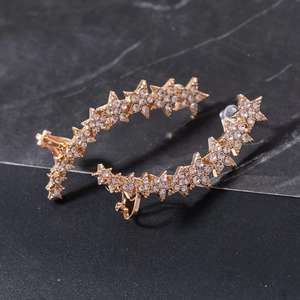 Elegant gold ear crawlers featuring a row of sparkling rhinestones in star shapes