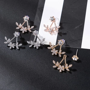 Detailed view of rhinestone flower ear jackets in silver, gold, and rose gold finishes