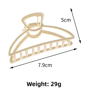 Detailed view of matte beige zinc alloy claw clip with hollow lines and size markings
