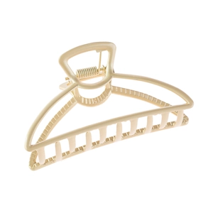 Detail of matte gold hollow metal hair claw clip with large size curved grip design