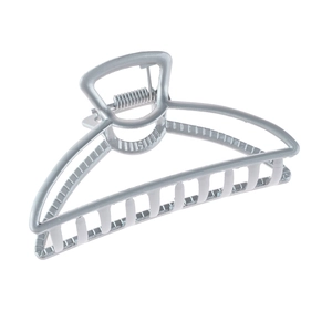 Detail view of large matte silver metal hair claw clip with hollow geometric design