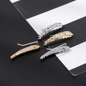 Golden and silver feather ear climbers with detailed leaf veins on a striped background