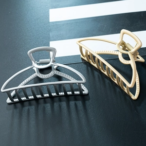 Detail of silver and matte gold hollow alloy hair claw clips with strong metal teeth