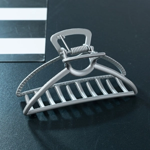 Macro shot of a silver matte finish zinc alloy hair claw clip with cutout lines and teeth