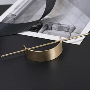 Minimalist gold metal hair pin set with a curved cuff and sleek brushed finish for women