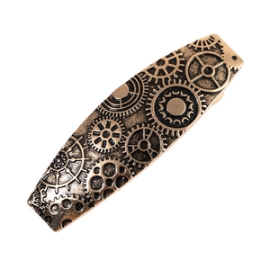Close-up of steampunk gear patterns on vintage bronze finish metal hair clip