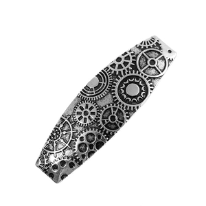 Detail view of vintage steampunk hair clip with intricate gear-shaped metal embossing