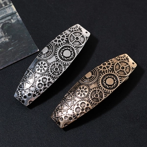 Detailed close-up of retro steampunk metal hairpins with intricate gear relief patterns