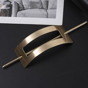 Detail view of golden matte brushed metal hair pin set with hollow rectangular design