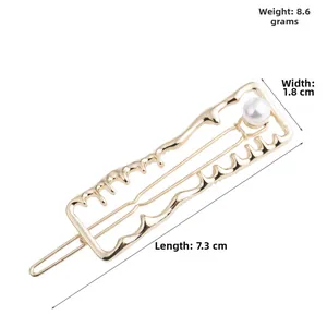 Detail showing gold irregular wave hair clip with pearl, size 7.3cm and 8.6g weight