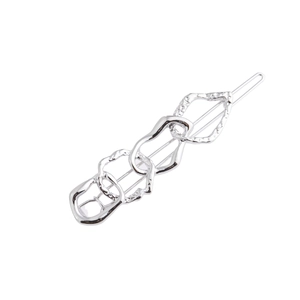Close-up of silver metal hair clip featuring abstract irregular chain links with hammered texture