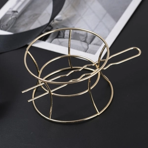 Detailed view of the wavy handle and sturdy base of a gold metal hair stick ornament
