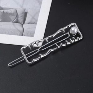 Silver alloy hair clip with irregular liquid wave design and white pearl on black background