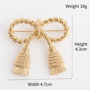 Elegant gold bow brooch with twisted rope texture and vintage tassel pendants for women