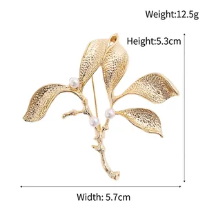 Golden leaf branch brooch with pearls and hammered texture, dimensions 5.3x5.7 cm and 12.5g