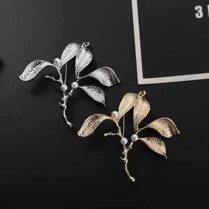 Detail of leaf branch brooch with pearls and textured gold and silver finish