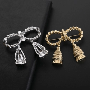 Elegant bow knot tassel brooches in gold and silver tones with twisted rope texture design