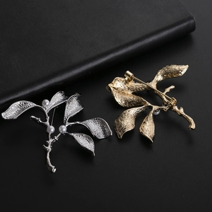 Elegant branch brooch with pearls in gold and silver finish on black leather base