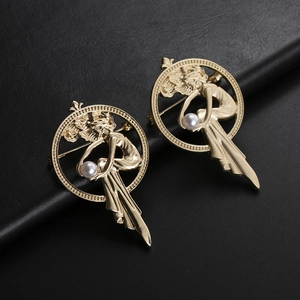 Art Nouveau gold brooch set featuring an elegant female figure holding a white pearl
