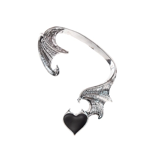 Detailed shot of silver dragon wing ear cuff with a glossy black heart pendant charm