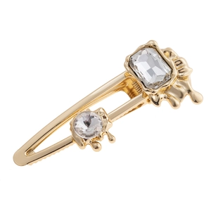 Lava-style gold-plated hair clip with rectangular and round clear crystals on white background