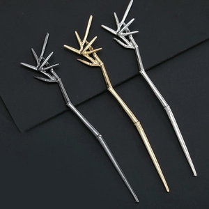 Bamboo-shaped hair sticks in gunmetal, gold, and silver finishes with leaf details