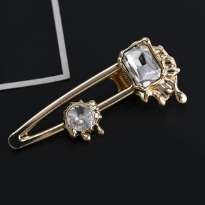 Golden hair clip with irregular lava metal design and square crystal gemstones