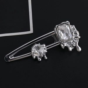 Lava style silver metal hair clip with rectangular and round clear crystals on black