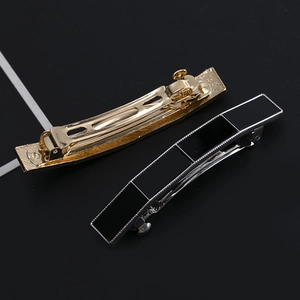 Elegant geometric black acrylic hair clip with silver knurled metal frame and spring grip